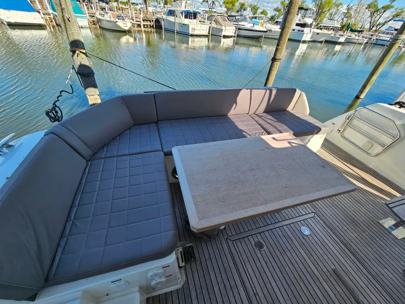 Slide: The Image of Prestige 460 Yacht 2018 with seating area by the water. - 14