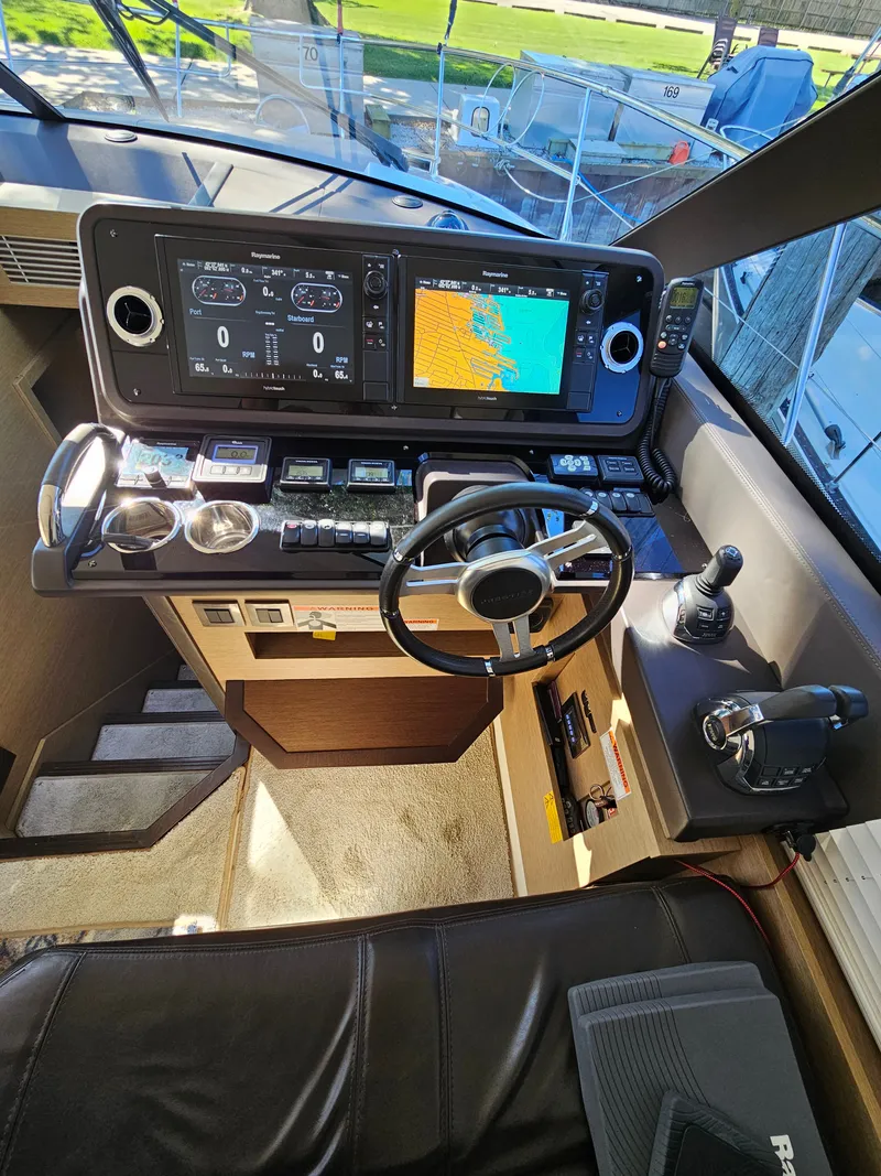 Slide: The Image of Prestige 460 yacht helm, 2018 model, featuring advanced navigation systems. - 21