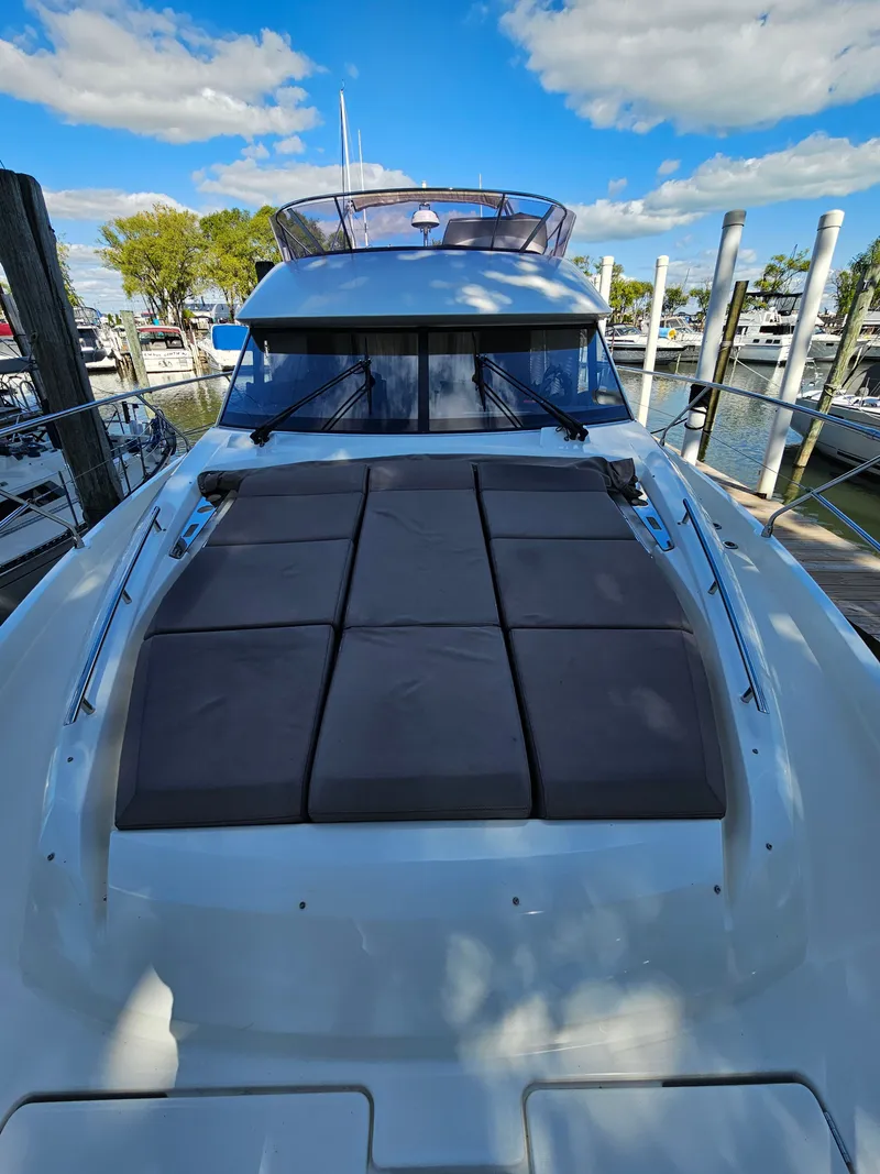 Slide: The Image of 2018 Prestige 460 yacht docked under sunny skies. - 7