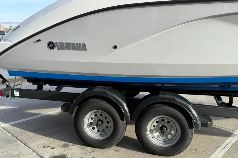 Slide: The Image of 2026 Yamaha Boats AR220 on trailer, side view with logo visible. - 13