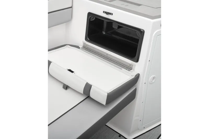 Slide: The Image of 2026 Yamaha Boats AR220 interior storage compartment with open hatch and cushioned seating. - 25