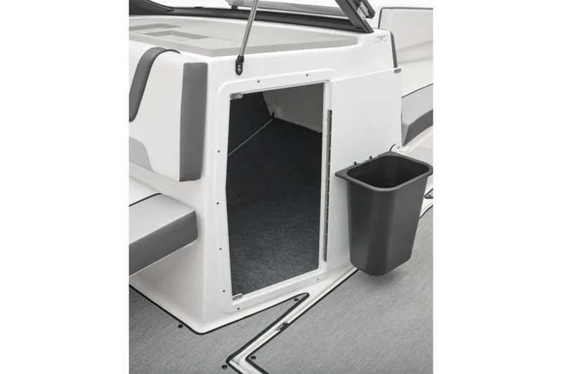 Slide: The Image of 2026 Yamaha Boats AR220 interior storage compartment with gray seating and black trash bin. - 26