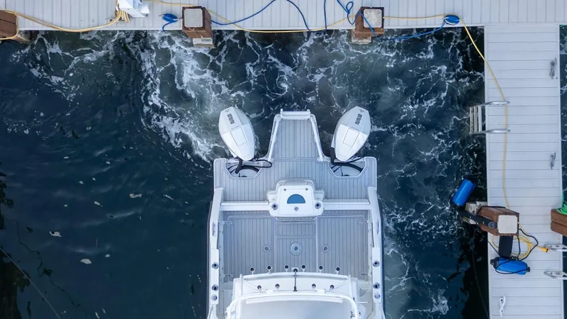 Slide: The Image of Aerial view of 2023 ArrowCat Flybridge Dual Helm boat docked at marina. - 28