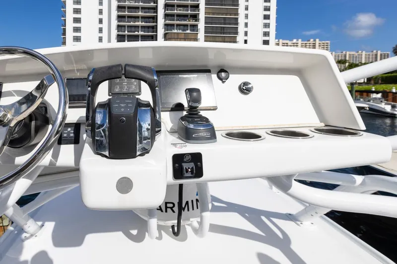 Slide: The Image of 2023 ArrowCat Flybridge Dual Helm with modern controls and cityscape background. - 32