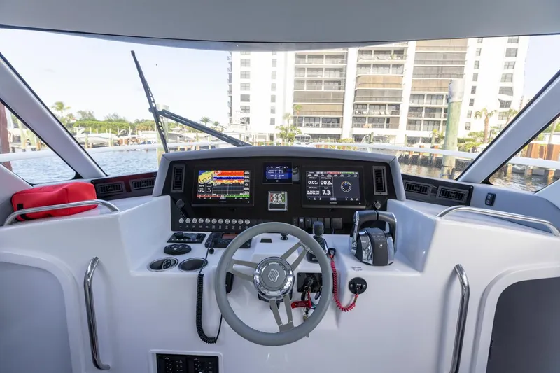 Slide: The Image of 2023 ArrowCat Flybridge Dual Helm with modern navigation controls and waterfront view. - 35