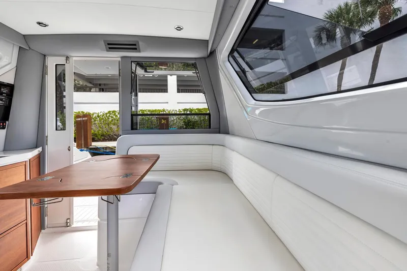 Slide: The Image of Luxurious interior of 2023 ArrowCat Flybridge Dual Helm with sleek seating and wooden table. - 39