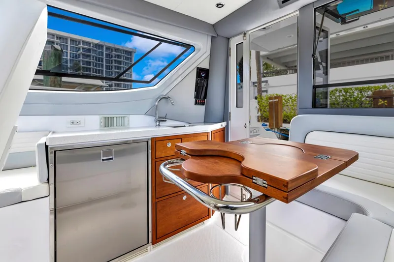 Slide: The Image of Luxurious interior of 2023 ArrowCat Flybridge Dual Helm with modern kitchenette and seating area. - 45