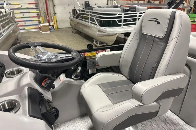 Slide: The Image of 2026 Bennington 22SXSR boat interior with steering wheel and captain's chair. - 12