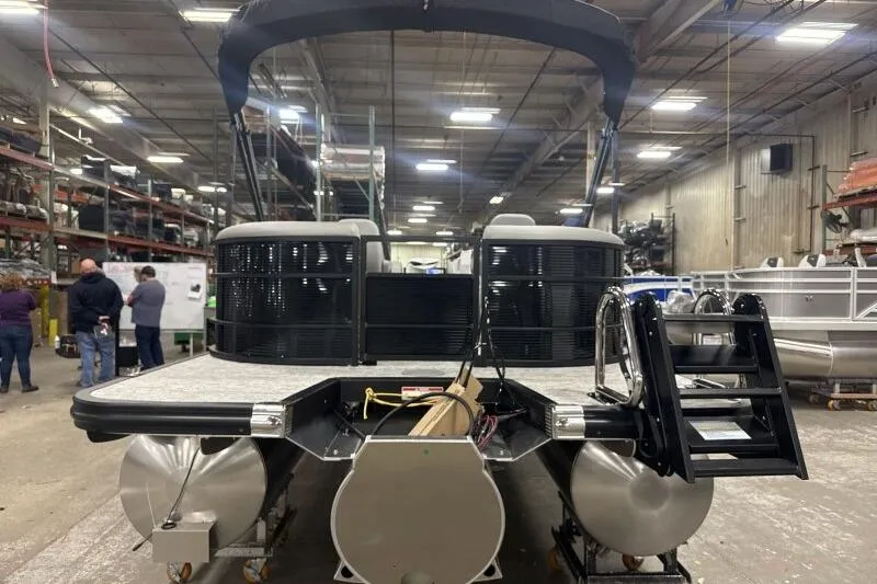 Slide: The Image of 2026 Bennington 22SXSR pontoon boat in a warehouse setting, rear view. - 15