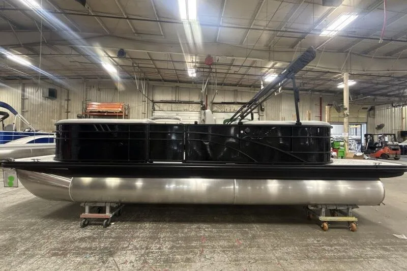 Slide: The Image of 2026 Bennington 22SXSR pontoon boat in a warehouse setting. - 4
