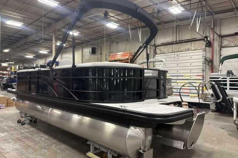 Slide: The Image of 2026 Bennington 22SXSR pontoon boat in a warehouse setting. - 5