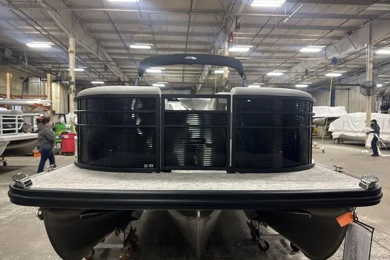 Slide: The Image of 2026 Bennington 22SXSR pontoon boat in a warehouse setting, front view. - 6