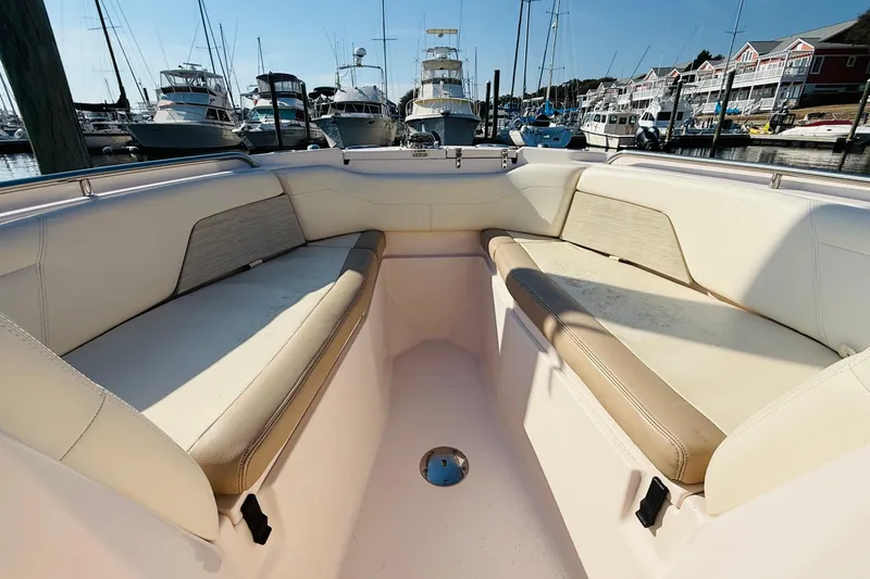 Slide: The Image of 2014 Grady-White Freedom 275 boat cockpit with steering wheel and controls. - 11