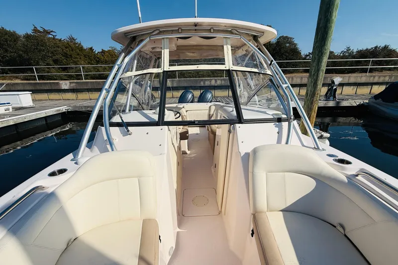 Slide: The Image of Bow of 2014 Grady-White Freedom 275 boat with anchor chain in marina setting. - 13