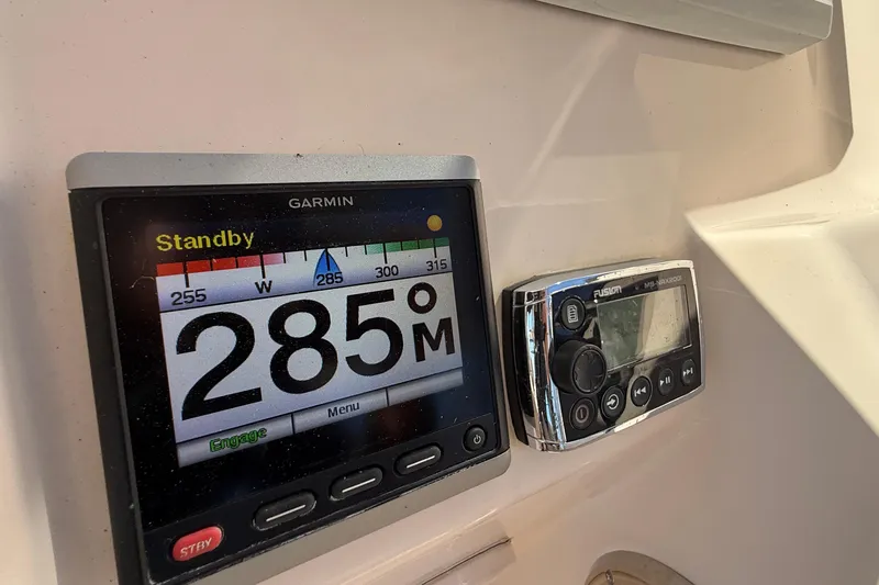 Slide: The Image of 2014 Grady-White Freedom 275 boat docked, featuring spacious seating and sleek design. - 14