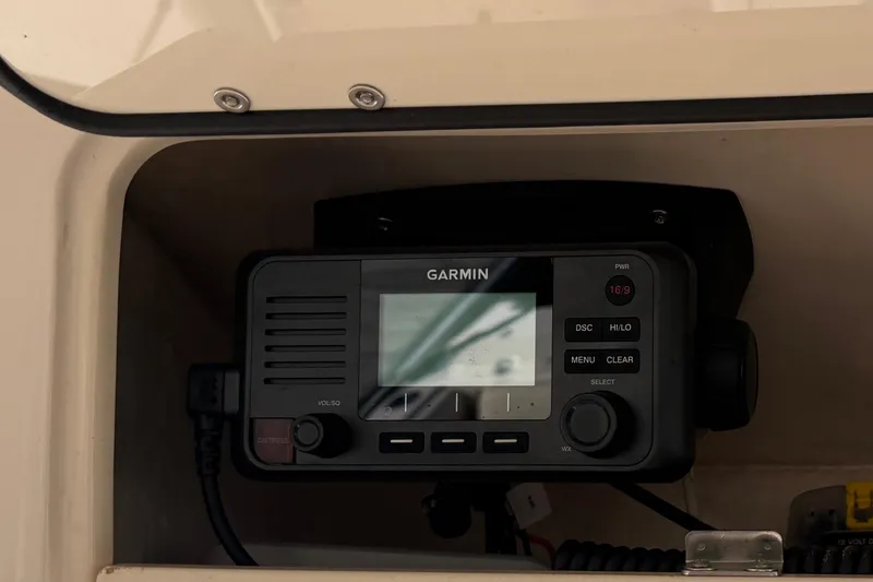 Slide: The Image of Garmin and Fusion displays on 2014 Grady-White Freedom 275 boat dashboard. - 16
