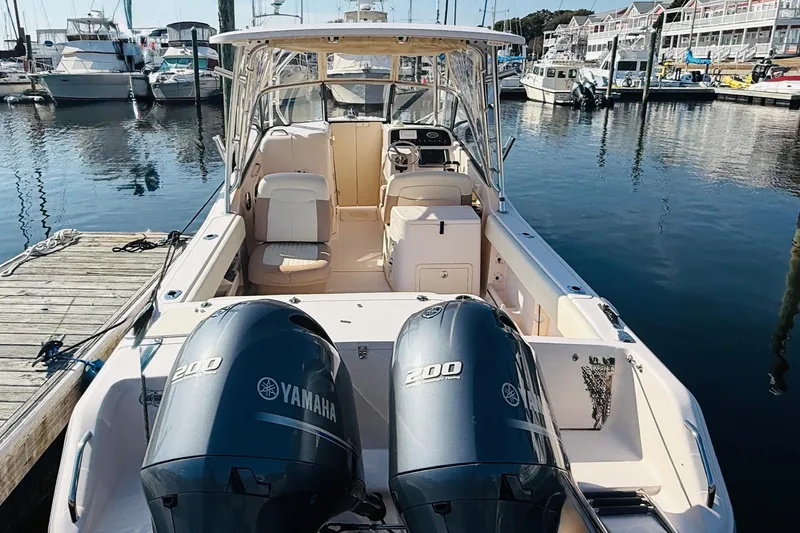 Slide: The Image of 2014 Grady-White Freedom 275 boat docked with twin Yamaha 200 engines. - 3
