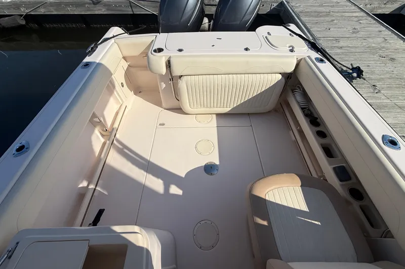 Slide: The Image of 2014 Grady-White Freedom 275 boat with twin Yamaha 200 engines docked at marina. - 4