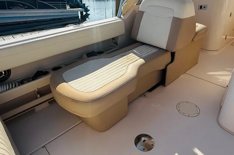 Slide: The Image of 2014 Grady-White Freedom 275 boat interior with seating and helm at marina. - 8