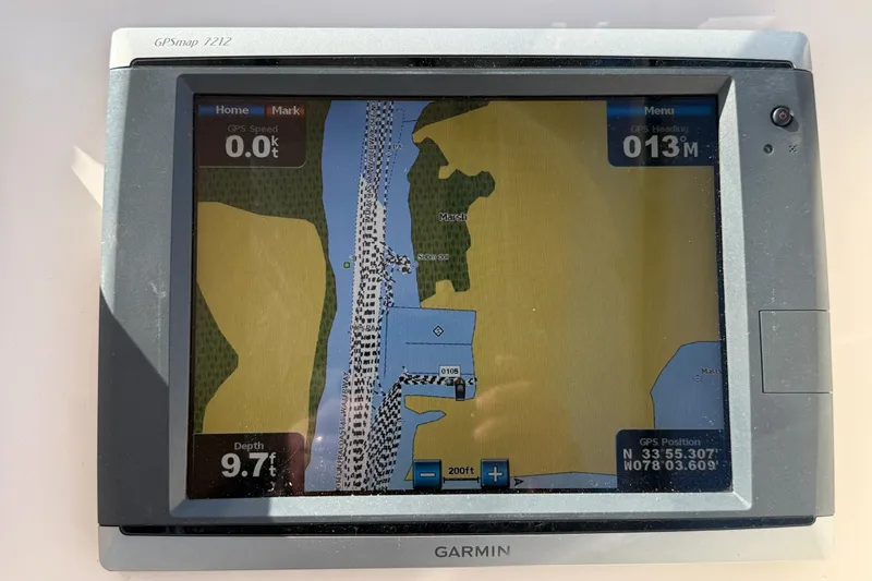 Slide: The Image of 2014 Grady-White Freedom 275 boat interior with beige seating and storage compartments. - 9