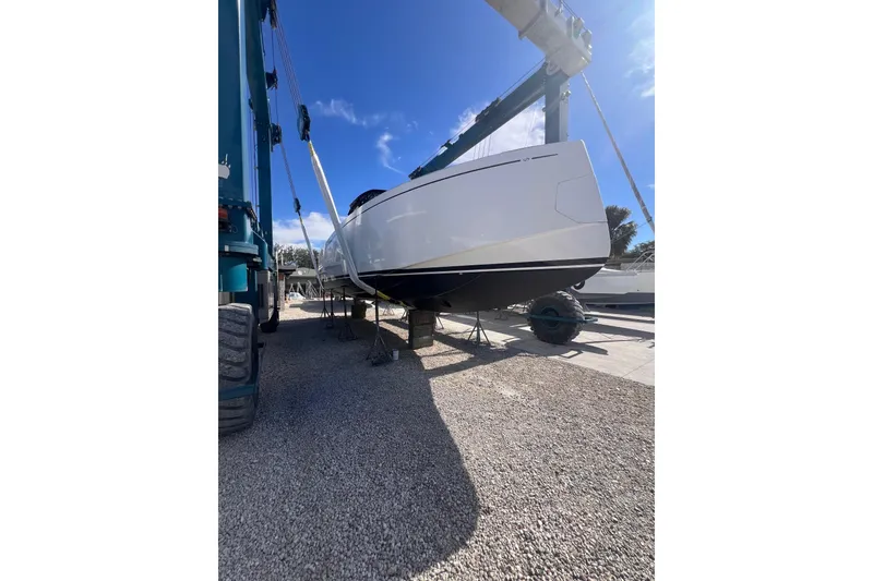 Slide: The Image of 2025 Pardo Yachts P38R on lift, sleek design, under clear blue sky. - 38