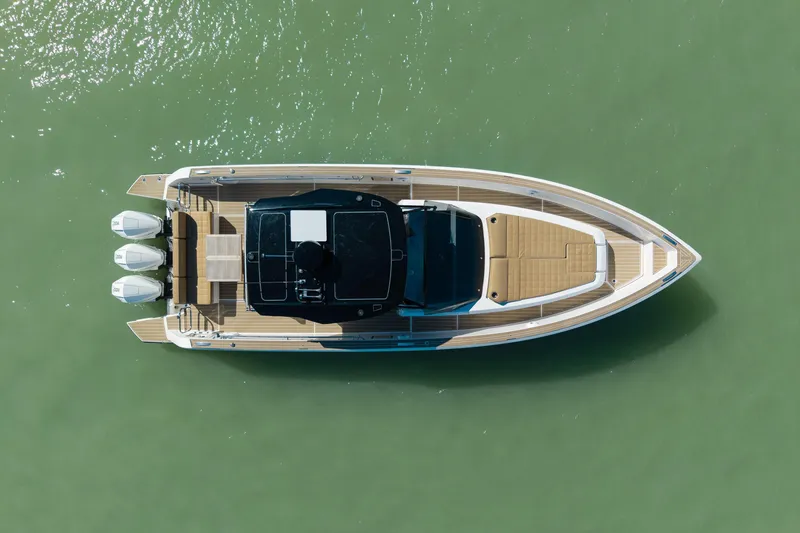 Slide: The Image of 2025 Pardo Yachts P38R with twin Mercury outboards, luxury seating, and sleek design on water. - 7