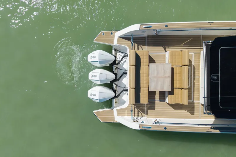 Slide: The Image of Top view of 2025 Pardo Yachts P38R luxury boat on green water. - 8