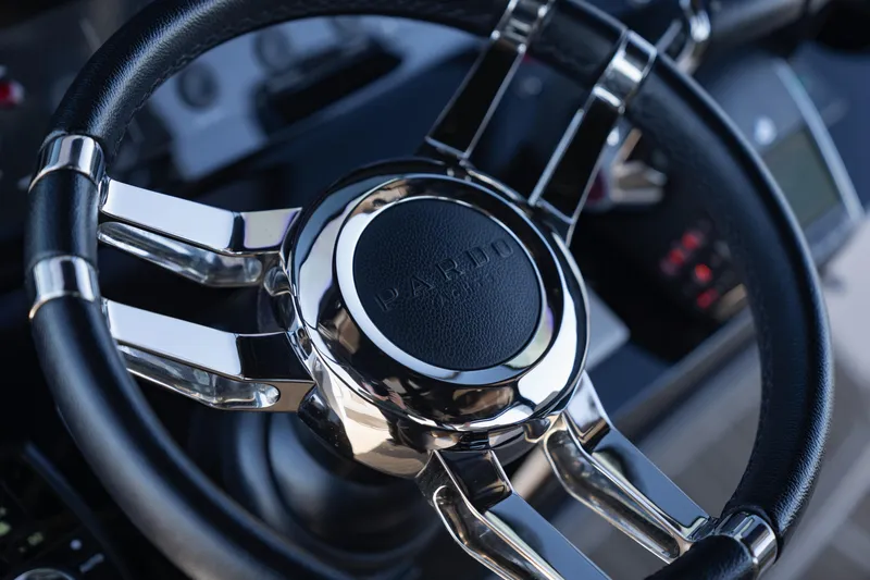 Slide: The Image of Steering wheel of 2025 Pardo Yachts P38R, featuring sleek chrome and leather design. - 21