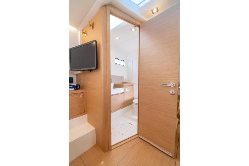 Slide: The Image of Interior of 2025 Pardo Yachts P38R, featuring modern wood finish and compact bathroom. - 25