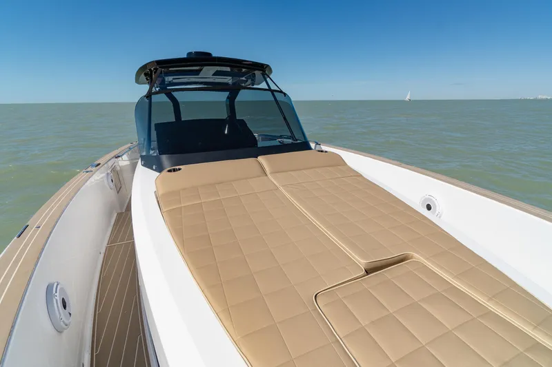 Slide: The Image of 2025 Pardo Yachts P38R luxury yacht with tan sunbed, cruising on calm waters. - 29