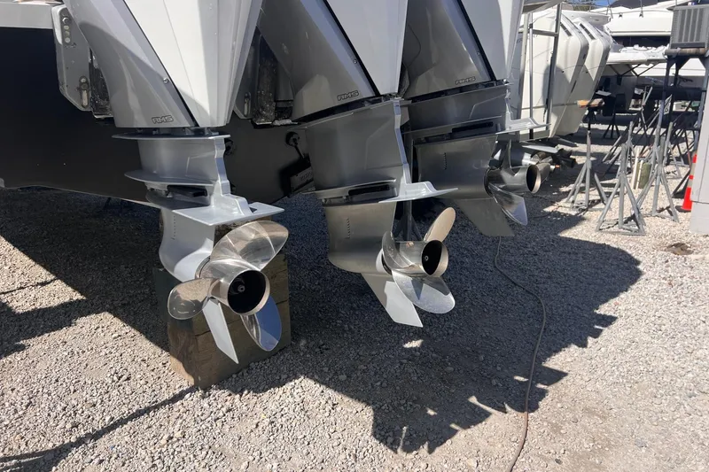 Slide: The Image of 2025 Pardo Yachts P38R outboard motors with propellers on gravel surface. - 35