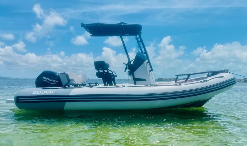 The Image of 2024 Zodiac Open 5.5 boat on clear water under a blue sky. - 0