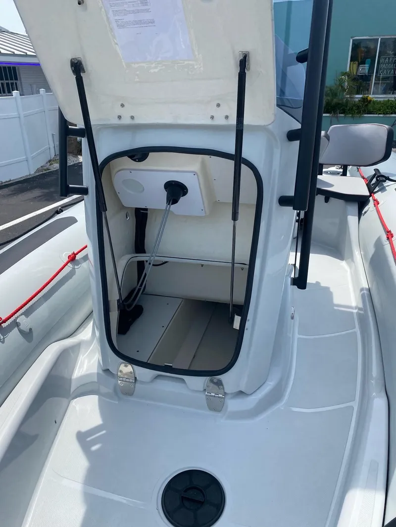 Slide: The Image of 2024 Zodiac Open 5.5 boat storage compartment with open hatch. - 10