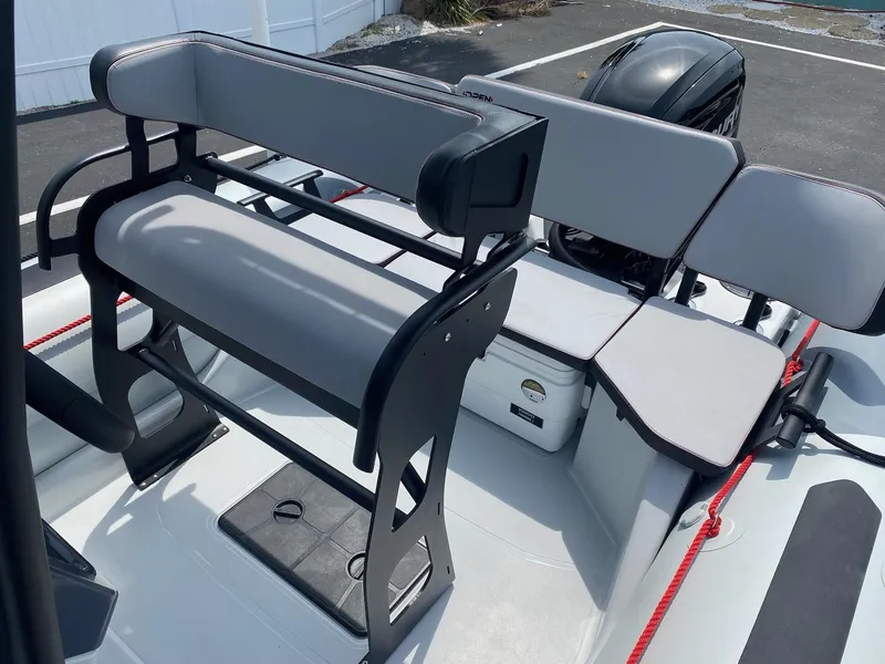 Slide: The Image of 2024 Zodiac Open 5.5 boat interior with seating and storage compartments. - 7