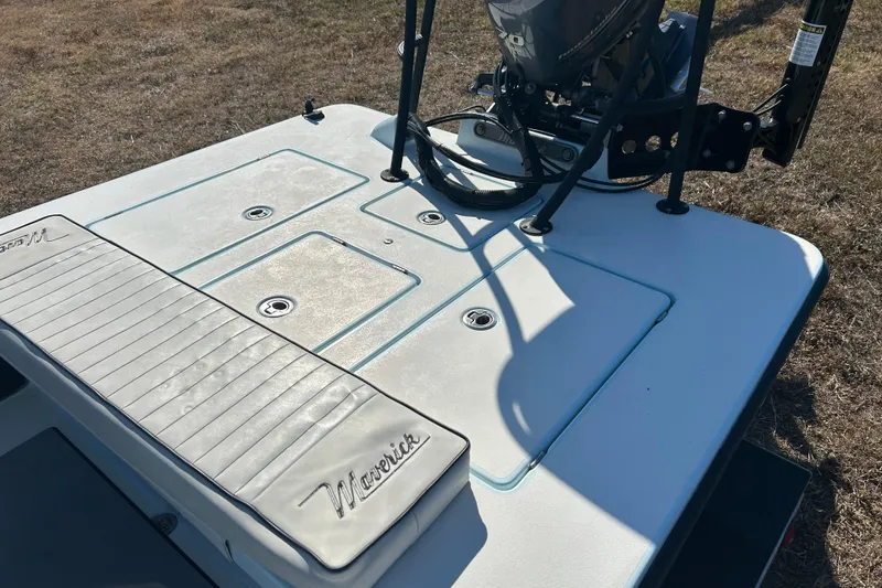 Slide: The Image of 2014 Maverick 17 HPX-S boat deck with motor, featuring storage compartments. - 11