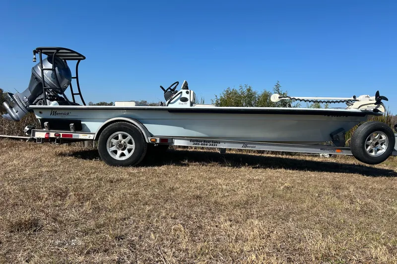 Slide: The Image of 2014 Maverick 17 HPX-S boat on trailer, parked on grass under clear blue sky. - 3