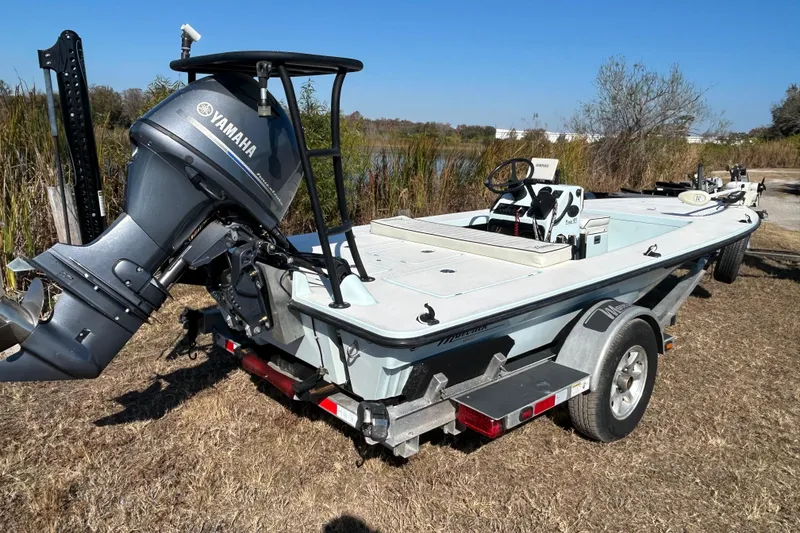 Slide: The Image of 2014 Maverick 17 HPX-S boat with Yamaha outboard motor on trailer, parked outdoors. - 4