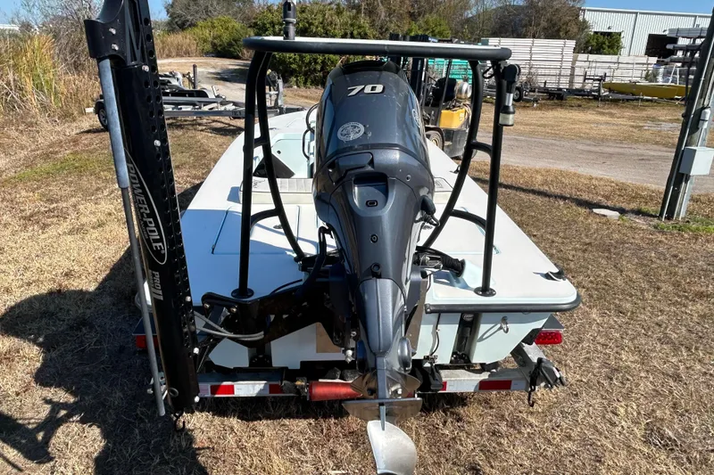Slide: The Image of 2014 Maverick 17 HPX-S boat with outboard motor on a trailer, parked outdoors. - 6