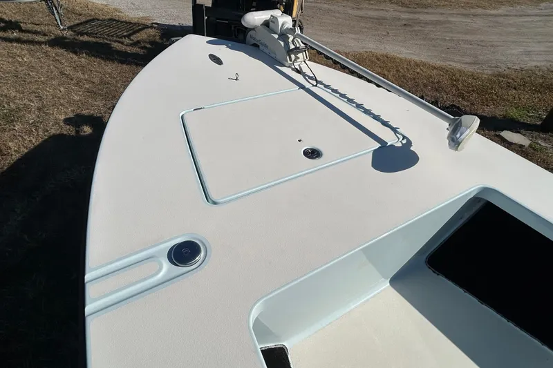 Slide: The Image of 2014 Maverick 17 HPX-S boat deck with trolling motor, parked on grass. - 7
