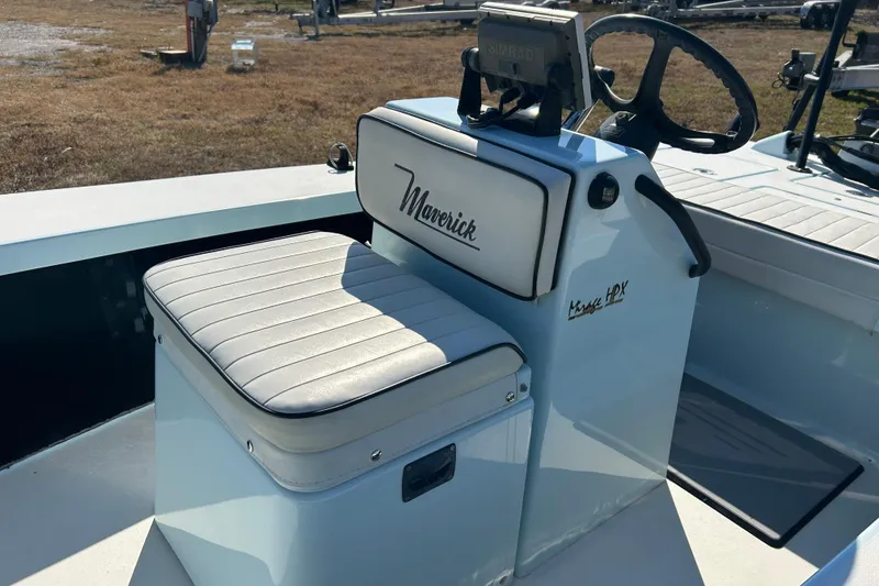 Slide: The Image of 2014 Maverick 17 HPX-S boat console with cushioned seat and steering wheel. - 8