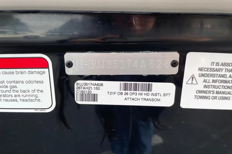 Slide: The Image of 2026 Tahoe T21 boat transom with safety and identification labels. - 121