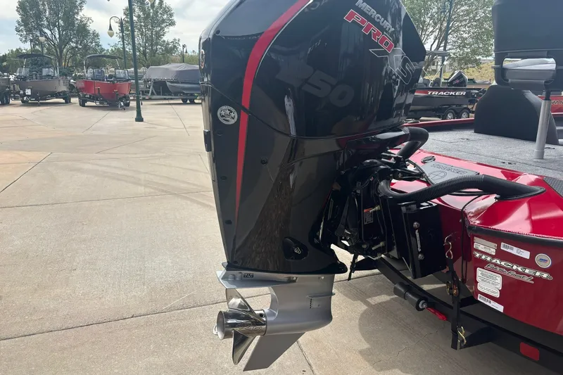 Slide: The Image of 2026 Tracker Savage 215 boat with Mercury Pro outboard motor in a showroom. - 19