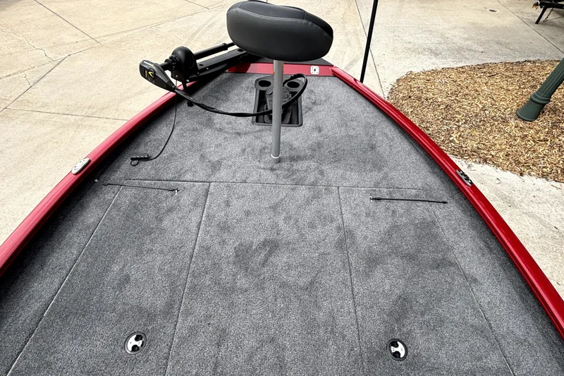 Slide: The Image of 2026 Tracker Savage 215 boat deck with gray carpet and red trim. - 15