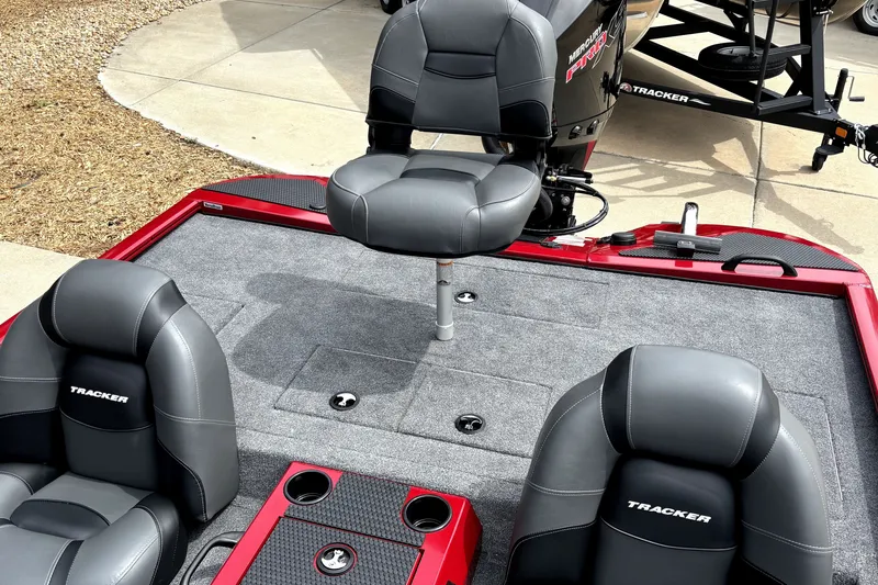 Slide: The Image of 2026 Tracker Savage 215 boat interior with gray seating and carpeted deck. - 14