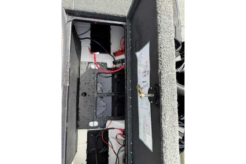 Slide: The Image of Open battery compartment of 2026 Nitro Z20 XL Pro boat, showing wiring and components. - 21