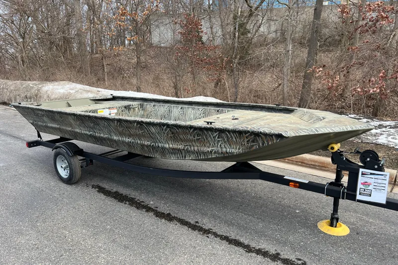 Slide: The Image of 2026 Tracker Grizzly 1648 Utility boat on trailer, parked on a road. - 2