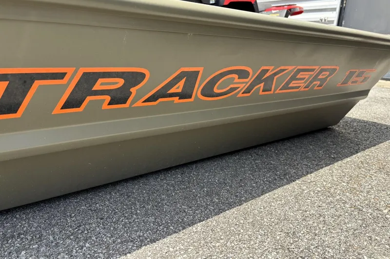 The Image of 2026 Tracker Grizzly 15 Jon boat side view with bold orange lettering. - 0