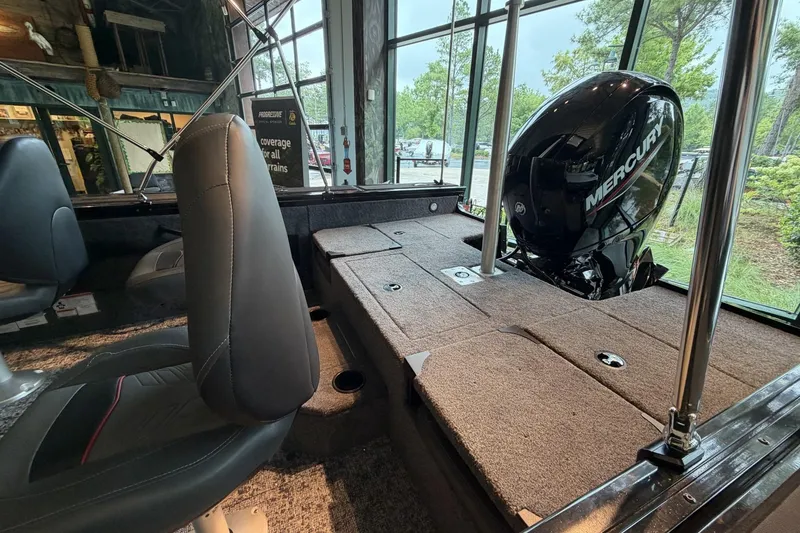 Slide: The Image of 2026 Tracker Targa V-18 Combo boat interior with Mercury engine, featuring comfortable seating. - 9