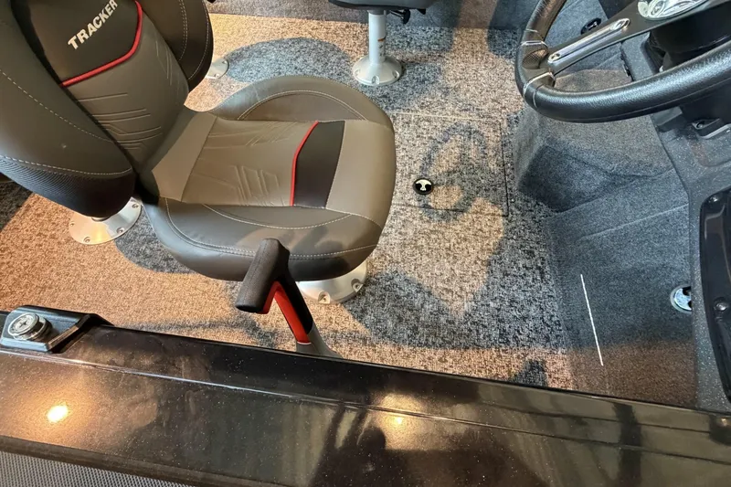 Slide: The Image of Interior of 2026 Tracker Targa V-18 Combo boat with seating and steering wheel. - 8