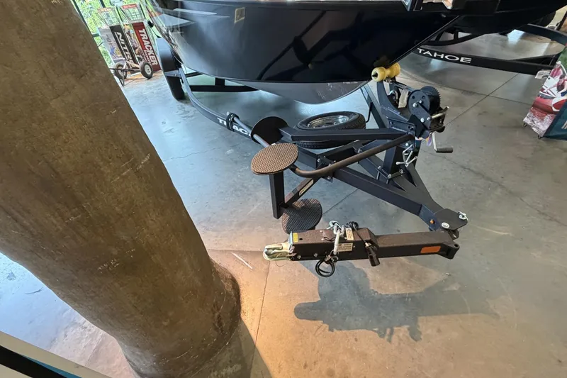 Slide: The Image of 2026 Tracker Targa V-18 Combo boat trailer hitch and winch system in showroom. - 6